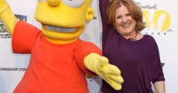 Nancy Cartwright poses with a Bart Simpson character, showcasing the iconic animated character from The Simpsons.