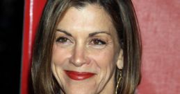 Wendie Malick smiling confidently in a stylish blazer, showcasing her timeless beauty and elegance at a red carpet event.