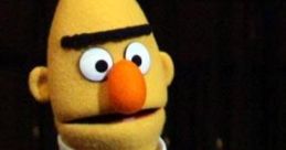 Bert, the beloved puppet from Sesame Street, wearing a colorful striped shirt and displaying a curious expression.