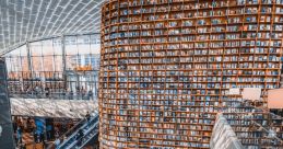 Modern library in a shopping center, featuring wooden bookshelves and study areas filled with people engaging in reading.