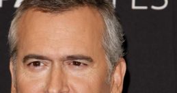 Bruce Campbell smiling at a red carpet event, showcasing his iconic style and charm, a beloved figure in horror cinema.