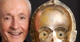 Anthony Daniels holds a C-3PO mask, showcasing his iconic role as the beloved droid in the Star Wars franchise.