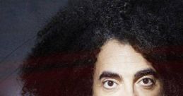 Caparezza, Italian rapper, showcasing his signature curly hairstyle and expressive gaze, embodying unique artistry and charisma.