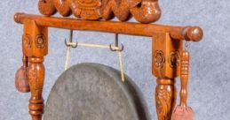 Chinese gong on an intricately carved wooden stand, featuring dragon motifs and striking mallets, ideal for library decor.