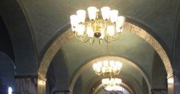 Grand empty entrance to a library featuring ornate chandeliers, archways, and marble columns, inviting tranquility and exploration.