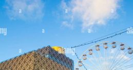 Ice skaters enjoy a winter day at the Birmingham Library, with a Ferris wheel in the background under a clear blue sky.