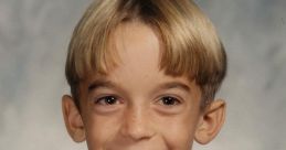 Smiling young boy with a bowl haircut, wearing a black and white zip-up jacket, exuding a cheerful vibe.