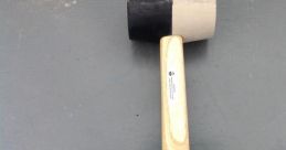 Rubber mallet with a black and gray head, featuring a wooden handle, ideal for library projects and non-damaging tasks.