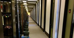 Library corridor lined with shelves, featuring trash bins for waste disposal, enhancing cleanliness and organization.