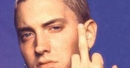 Eminem in the Slim Shady era, showcasing his iconic style and rebellious attitude, with a striking tattoo and assertive pose.