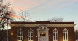 Hamburg Library's historic brick building at dusk, showcasing elegant architecture and inviting entryway.