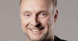 Smiling portrait of Frank Buschmann in a black blazer, showcasing his friendly personality and professionalism.