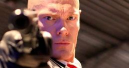 Hitman Agent 47, dressed in a suit, aims a gun with intense focus, embodying the iconic assassin character.