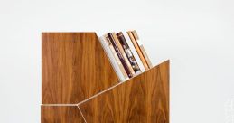 Stylish irregular library shelving unit with unique angles, featuring wooden finish and books displayed creatively.