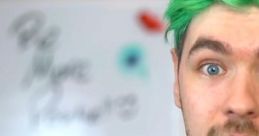 JackSepticEye, known for his vibrant green hair, engages viewers with a friendly expression and motivational backdrop.