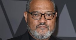 Laurence Fishburne at a red carpet event, showcasing a stylish black tuxedo and distinctive bow tie.