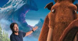 Ray Romano poses with Manfred from Ice Age, showcasing the beloved mammoth in a vibrant snowy landscape.