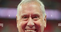 Martin Tyler smiles warmly, known for his passionate FIFA commentary and iconic voice in football broadcasting.