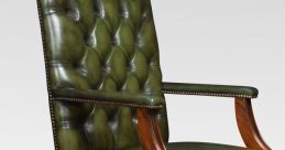 Green leather armchair with tufted design, perfect for leather handling library settings. Elegant wooden frame enhances decor.