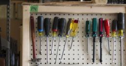 Variety of hand tools and screwdrivers organized on a pegboard in a Multi-Tool Library for DIY and repair projects.