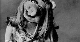 Miss Piggy by Frank Oz, glamorous in a shimmering gown, showcasing her iconic style and personality, exuding confidence.