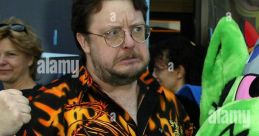 Roger L. Jackson, known as Mojo Jojo, poses with a vibrant shirt featuring martial arts imagery at a public event.