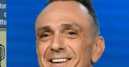 Hank Azaria smiling at an event, known for voicing Ned Flanders in The Simpsons, showcasing his charismatic personality.