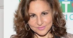 Kathy Najimy smiles at an event, showcasing her signature style and charm as the voice of Peggy Hill in King of the Hill.