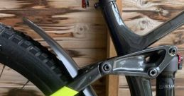 Close-up of a mountain bike's rear mudguard and frame, showcasing sleek design and durability for optimal performance.