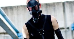 Psycho Mantis cosplay featuring a character in a gas mask and dark outfit, embodying stealth and mystery in a urban setting.