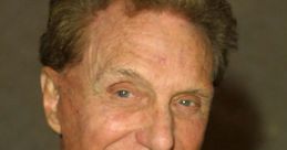 Robert Stack smiling in a tuxedo, known for his iconic roles in film and television, exuding classic Hollywood charm.