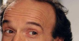 Roberto Benigni smiling, showcasing his charismatic personality in a casual setting. Celebrated Italian actor and director.