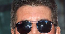 Simon Cowell smiling with sunglasses at a public event, showcasing his iconic style and confident personality.