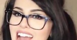 SSSniperWolf smiling with glasses, showcasing her playful personality and vibrant style, popular among gaming fans.