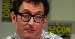 Tom Kenny speaking at a convention panel, sharing insights about his role as The French Narrator in popular media.