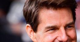 Tom Cruise smiles confidently at an event, showcasing his signature style and charismatic presence.