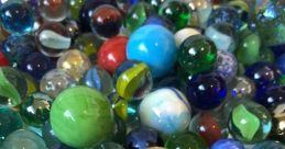 Marbles The of marbles being spilled from a bag onto a table is a delightful cacophony of tinkling glass. As each marble