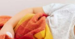 Cozy blanket wrapped around a person resting on a sofa, ideal for comfort when feeling sick or unwell.