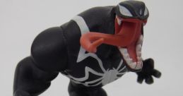 Venom figure from Disney Infinity-Marvel poses aggressively on a rocky base, showcasing detailed black and white design.