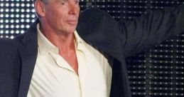 Vince McMahon in a black suit and open shirt, posing confidently against a vibrant backdrop of lights.