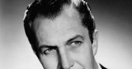 Vincent Price exudes charisma in a classic black-and-white portrait, tailored suit and distinctive mustache enhancing his charm.