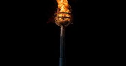 Vintage torch with flames, casting a warm glow against a black background, ideal for outdoor events or atmospheric settings.