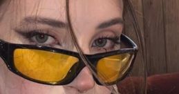 Stylish Russian girl with yellow sunglasses, flawless makeup, and bold nails, exuding modern fashion and confidence.