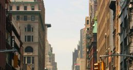 Busy urban street scene with cars, pedestrians, and tall buildings under a bright sky in a metropolitan area.