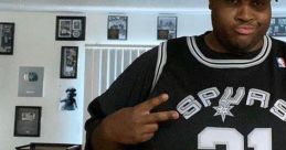 Man wearing a Spurs jersey and cap, posing confidently in an interior with sports memorabilia. Celebrating fan culture.