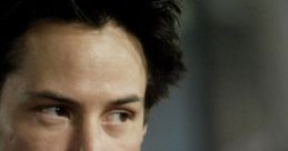 Close-up of Keanu Reeves portraying Neo, showcasing his intense expression and iconic style amidst a blurred backdrop.