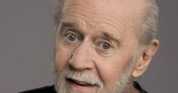 George Carlin smiling and gesturing, showcasing his iconic comedic style and engaging personality in a black shirt.