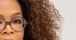 Oprah Winfrey with curly hair, glasses, and a thoughtful expression, highlighting her iconic style and charisma.