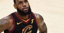 LeBron James in a black Cavaliers jersey, focused and determined during an intense NBA game.