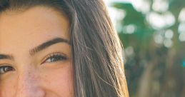 Smiling young woman with long hair in natural light, showcasing a confident and cheerful demeanor, ideal for social media.